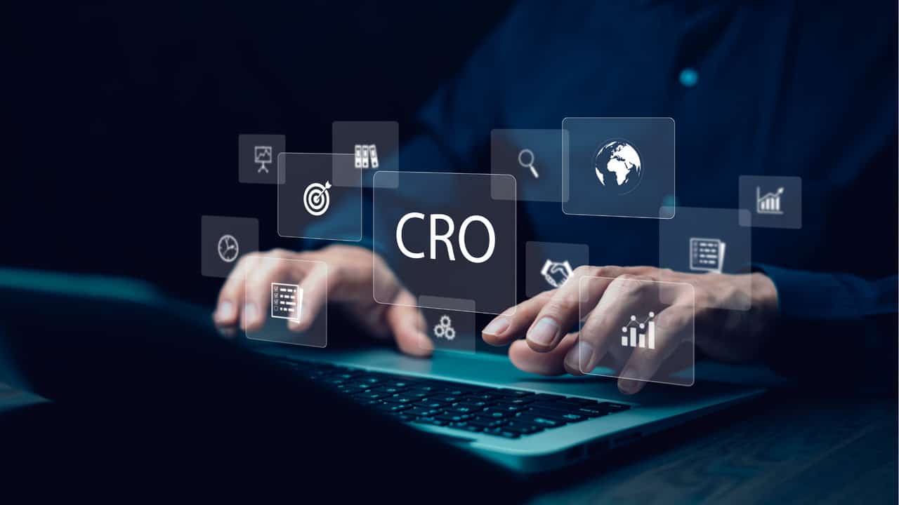 Person typing with CRO icon representing conversion rate optimization